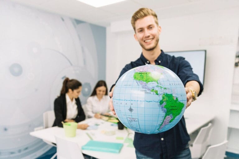A man holding a globe in his hands
